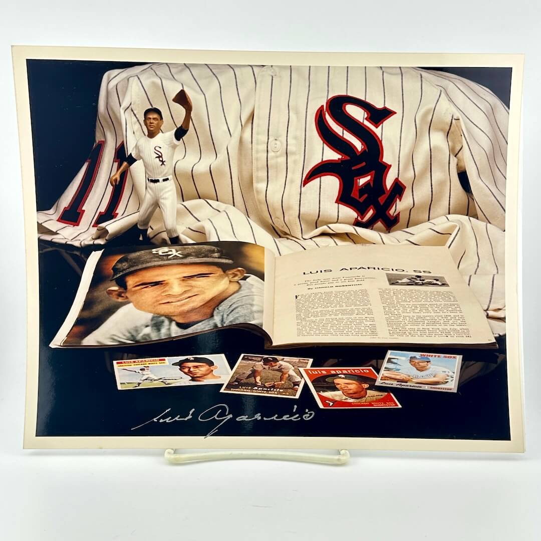 Photo of arranged baseball memorabilia featuring Luis Aparicio and his signature.