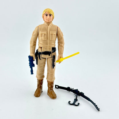Toy figure in beige outfit with weapons on a light gray background