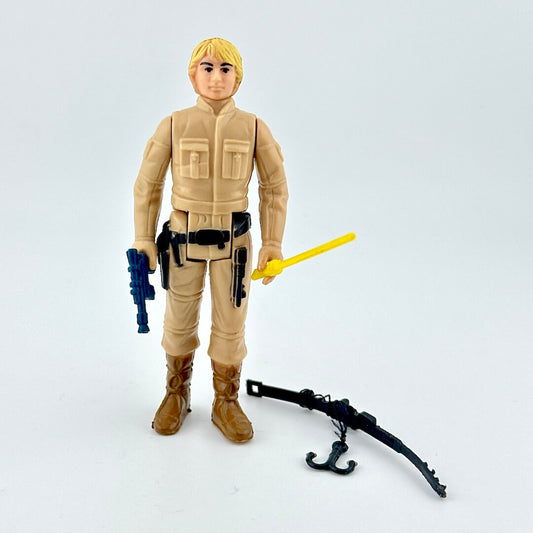 Toy figure in beige outfit with weapons on a light gray background