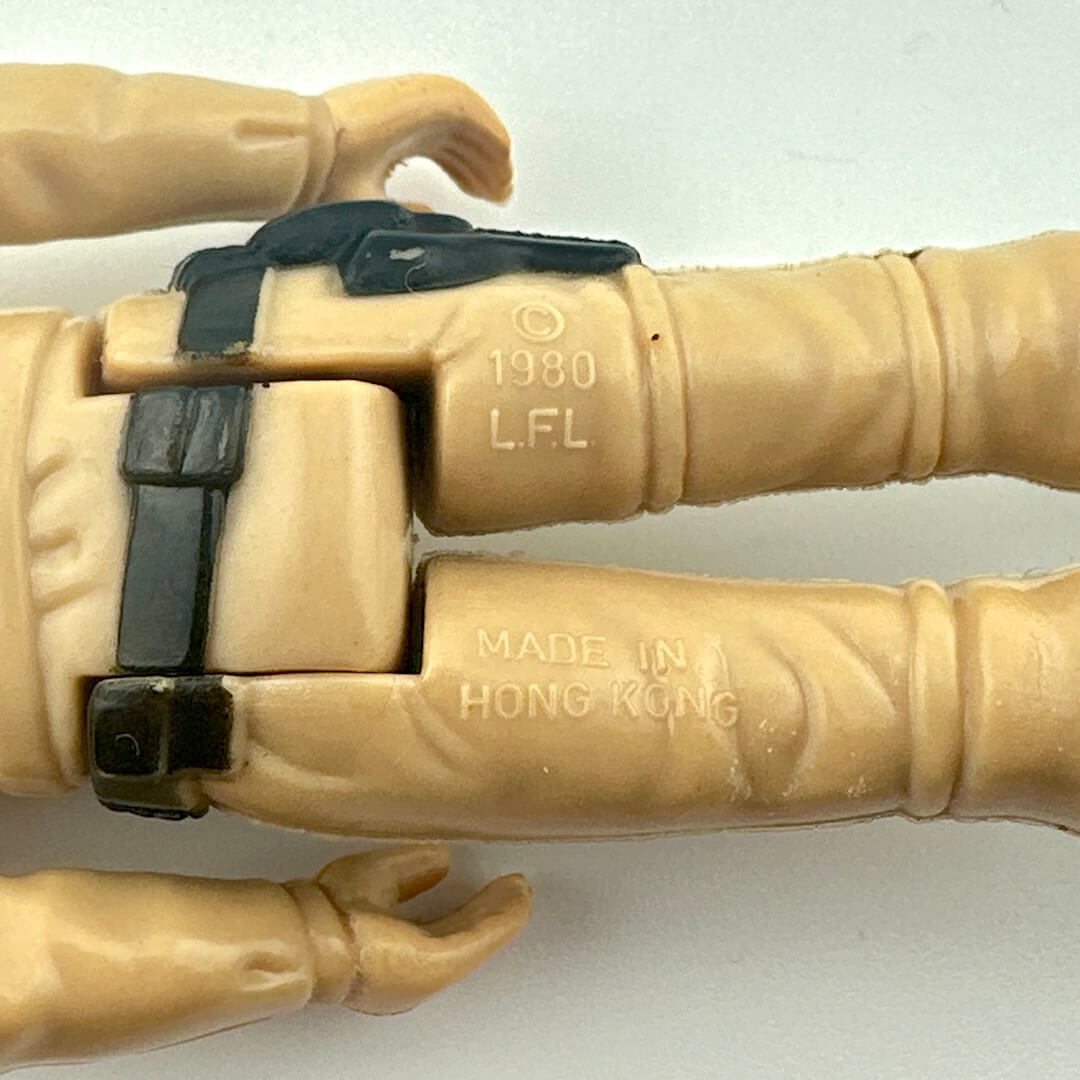 Back of figure's legs to show COO and copyright information.