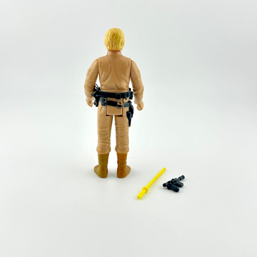 White male action figure with blonde hair in khaki military outfit with accessory belt against white background