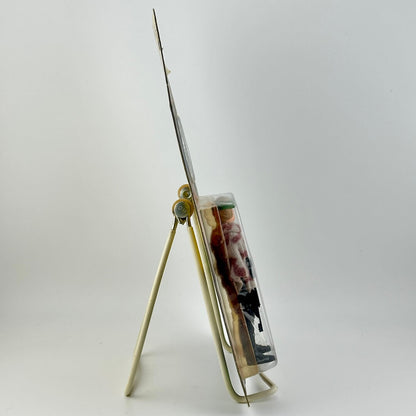 Side view of Star Wars action figure in packaging on easel against white background.