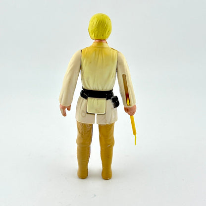 Action figure in a yellow and beige outfit holding a lightsaber on a white background