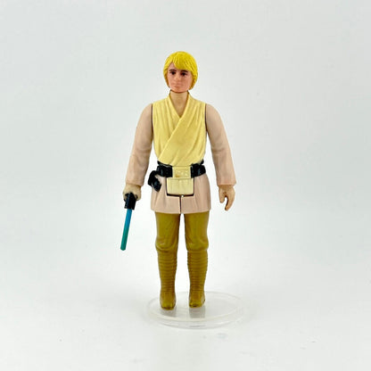 Action figure in a beige and yellow outfit with a blue lightsaber on a white background