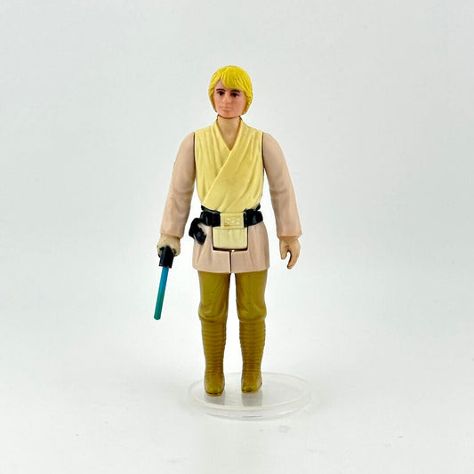Action figure in a beige and yellow outfit with a blue lightsaber on a white background
