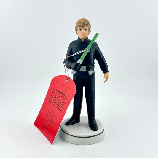 Star Wars figurine with a green lightsaber and red tag on a white background