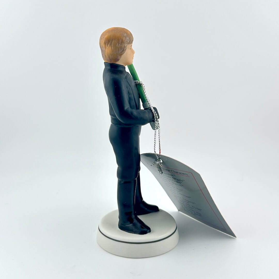 Star Wars figurine with a green lightsaber and red tag on a white background
