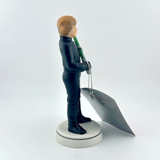 Star Wars figurine with a green lightsaber and red tag on a white background
