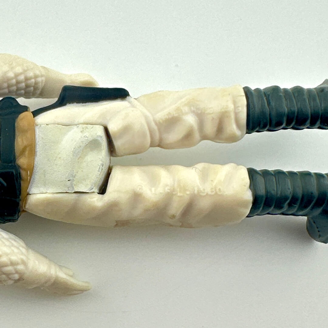 Close-up of a character's hand with a weapon on a white background