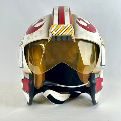 A replica sci-fi helmet featuring a large gold-tinted visor, and red, white and yellow markings. 