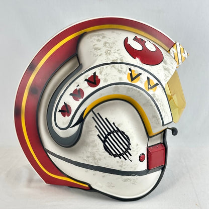 A Star Wars-themed helmet replica, featuring a distressed white base with red, yellow, and black markings.