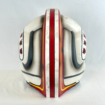 Back view of Luke Skywalker replica helmet with red, black, and yellow accents. 