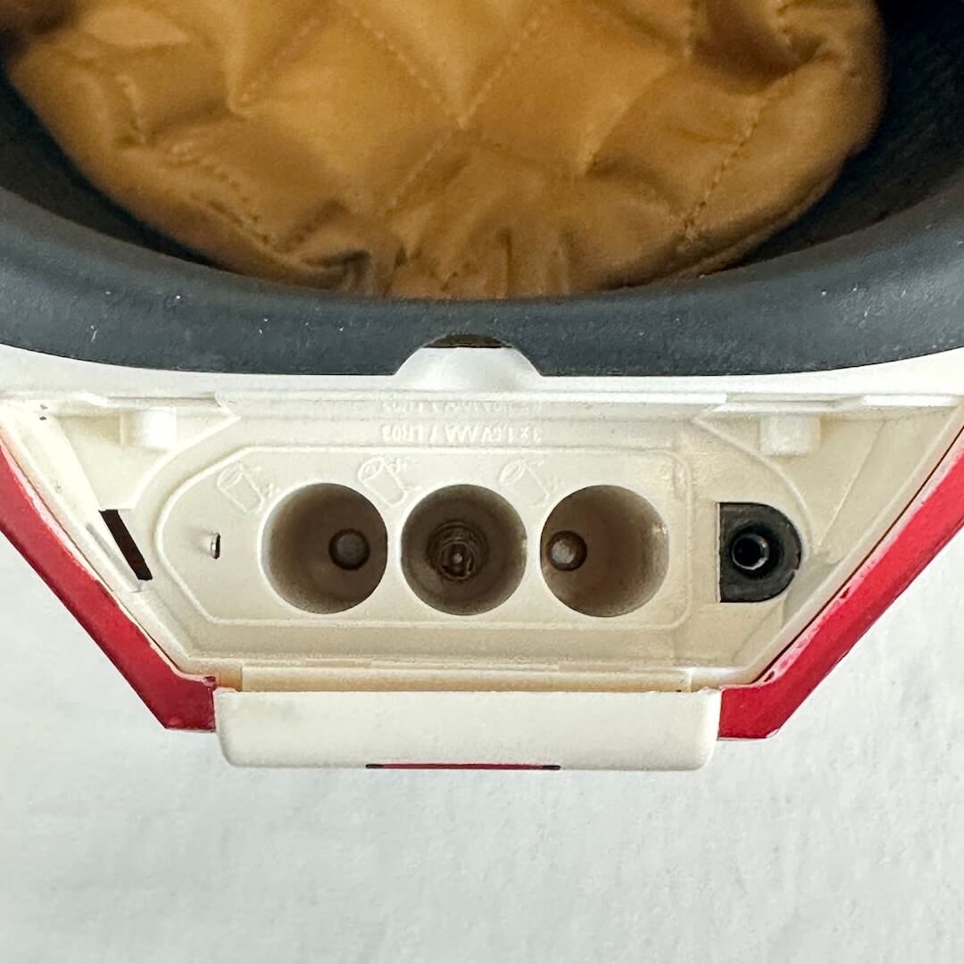 Close-up of battery compartment for three AAA batteries showing no signs of corrosion. 