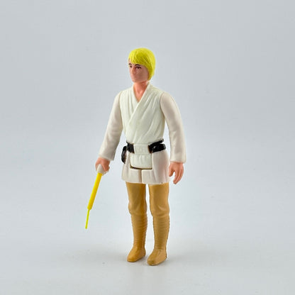White male action figure with yellow hair in white shirt, black belt & tan pants, yellow lightsaber emerging from right hand.
