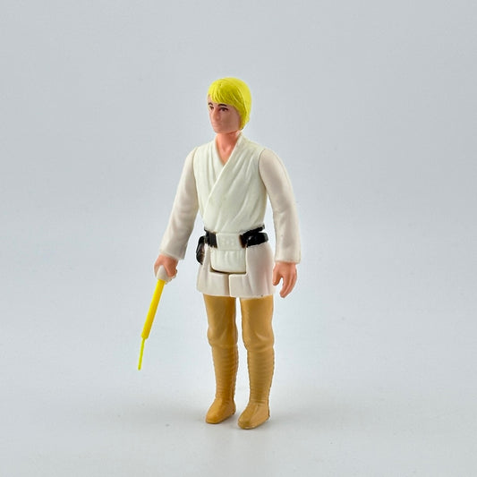 White male action figure with yellow hair in white shirt, black belt & tan pants, yellow lightsaber emerging from right hand.