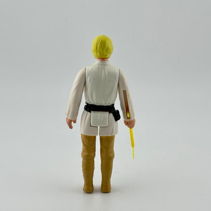 White male action figure with yellow hair in white shirt, black belt & tan pants, yellow lightsaber emerging from right hand.