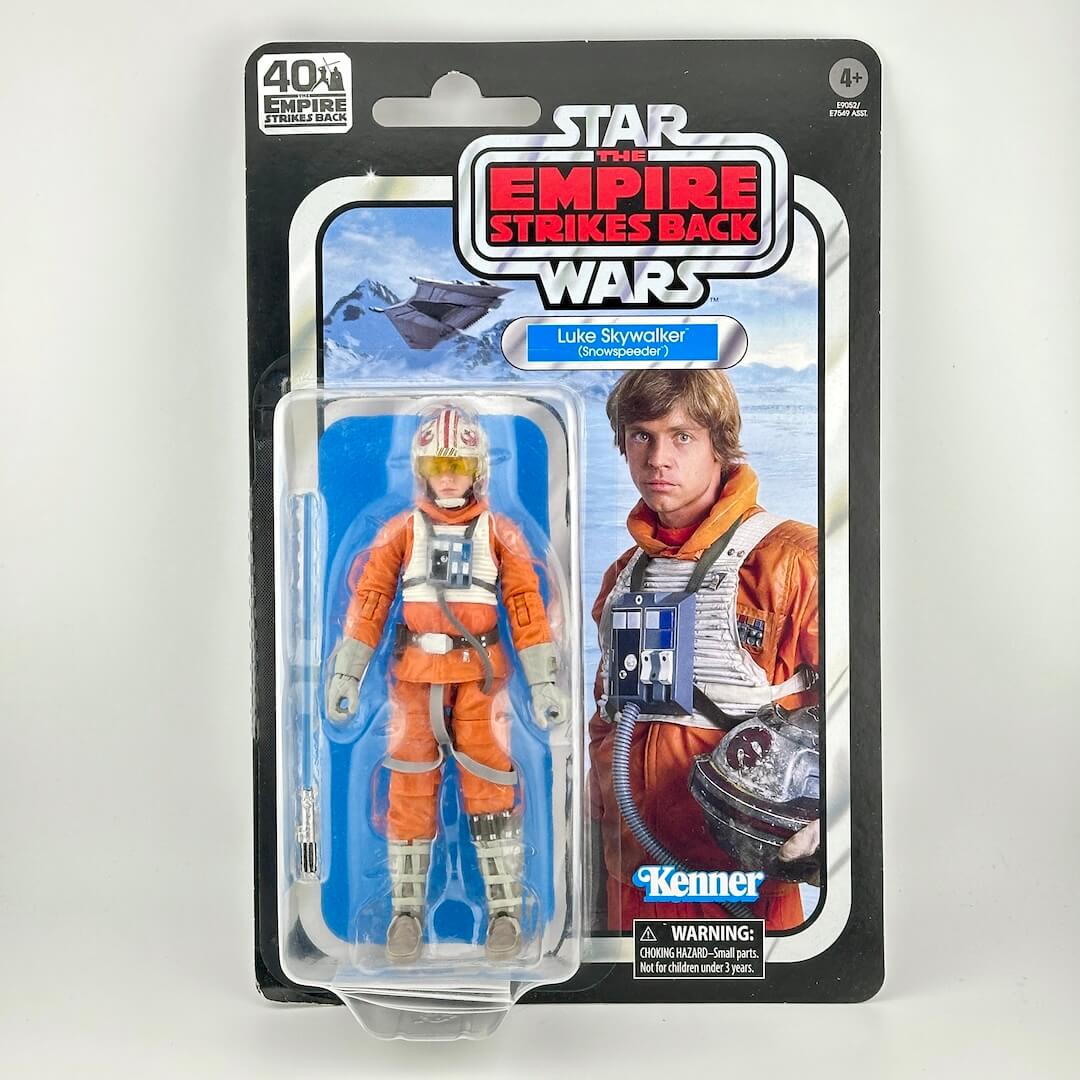 Star Wars action figure in its original blister packaging with retro-style card back; figure is in orange flight suit.