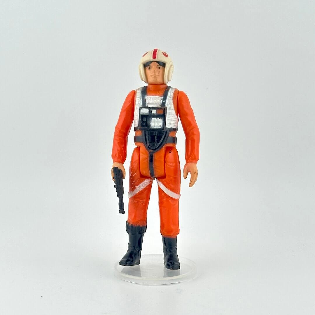 Action figure in an orange suit with a helmet on a white background