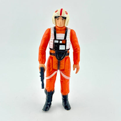 Action figure in orange jumpsuit with helmet on a light gray background