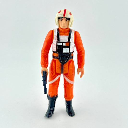 Action figure in orange jumpsuit with helmet on a light gray background
