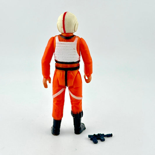 Action figure in orange and white jumpsuit with helmet on a light gray background