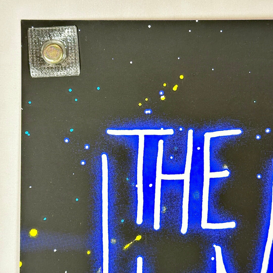 Top left corner of poster with crisp corner and clean edges. 
