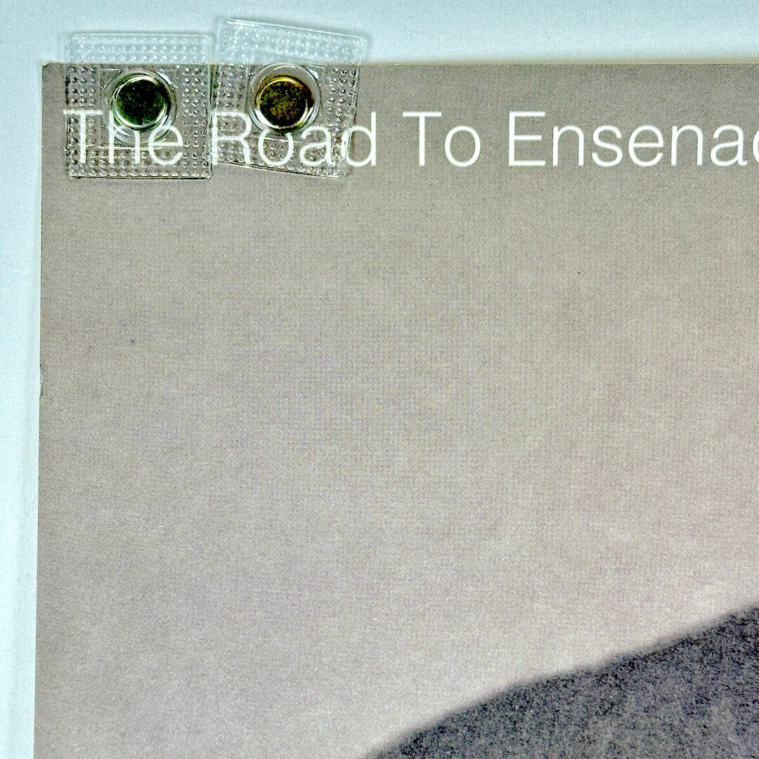 Top left corner of poster with rolled corner and good edges.