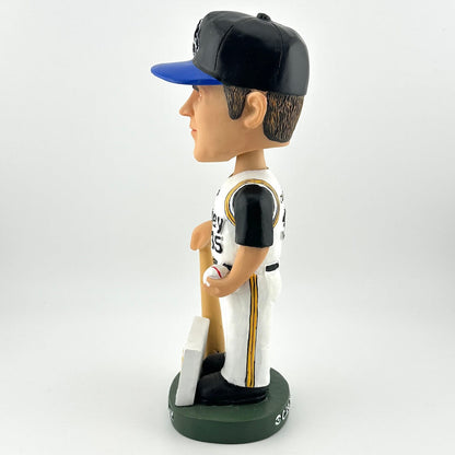 Bobblehead figure of a baseball player in a black and blue cap, white and black uniform with gold accents, holding a bat on a white background.