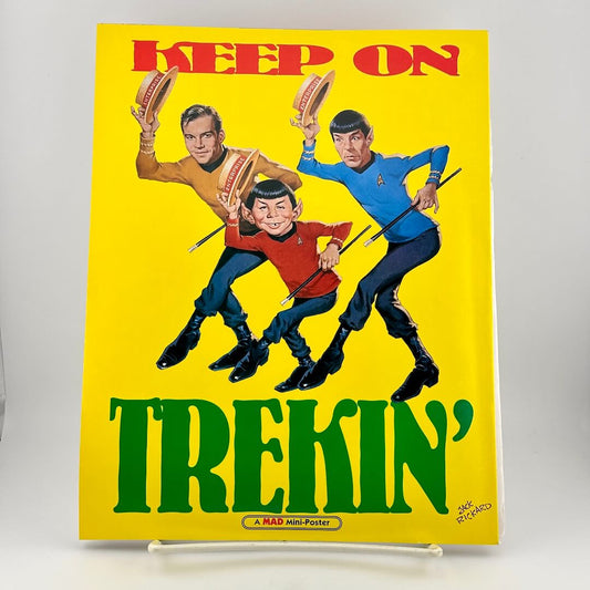 Cartoon illustration of three characters with text 'Keep on Trekin'' on a yellow background