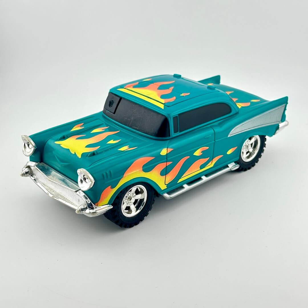 A teal toy hot rod car with yellow, orange, and red flame decals, chrome details, and black tires.