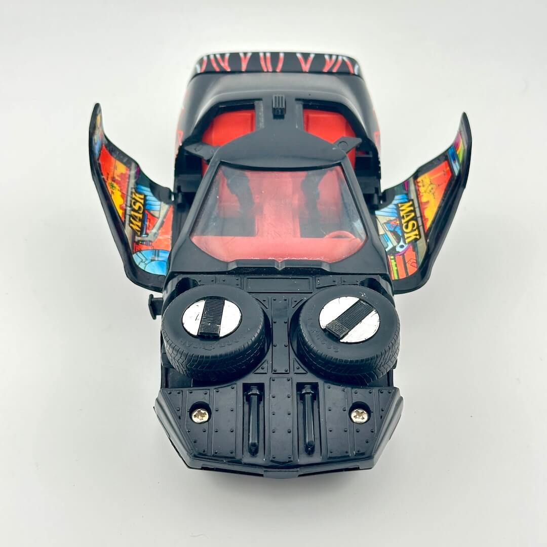 Front view of black vehicle with open wing doors and orange interior. 