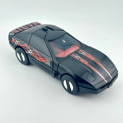 A black toy sports car with red and white flame decals, shown on a light gray background.