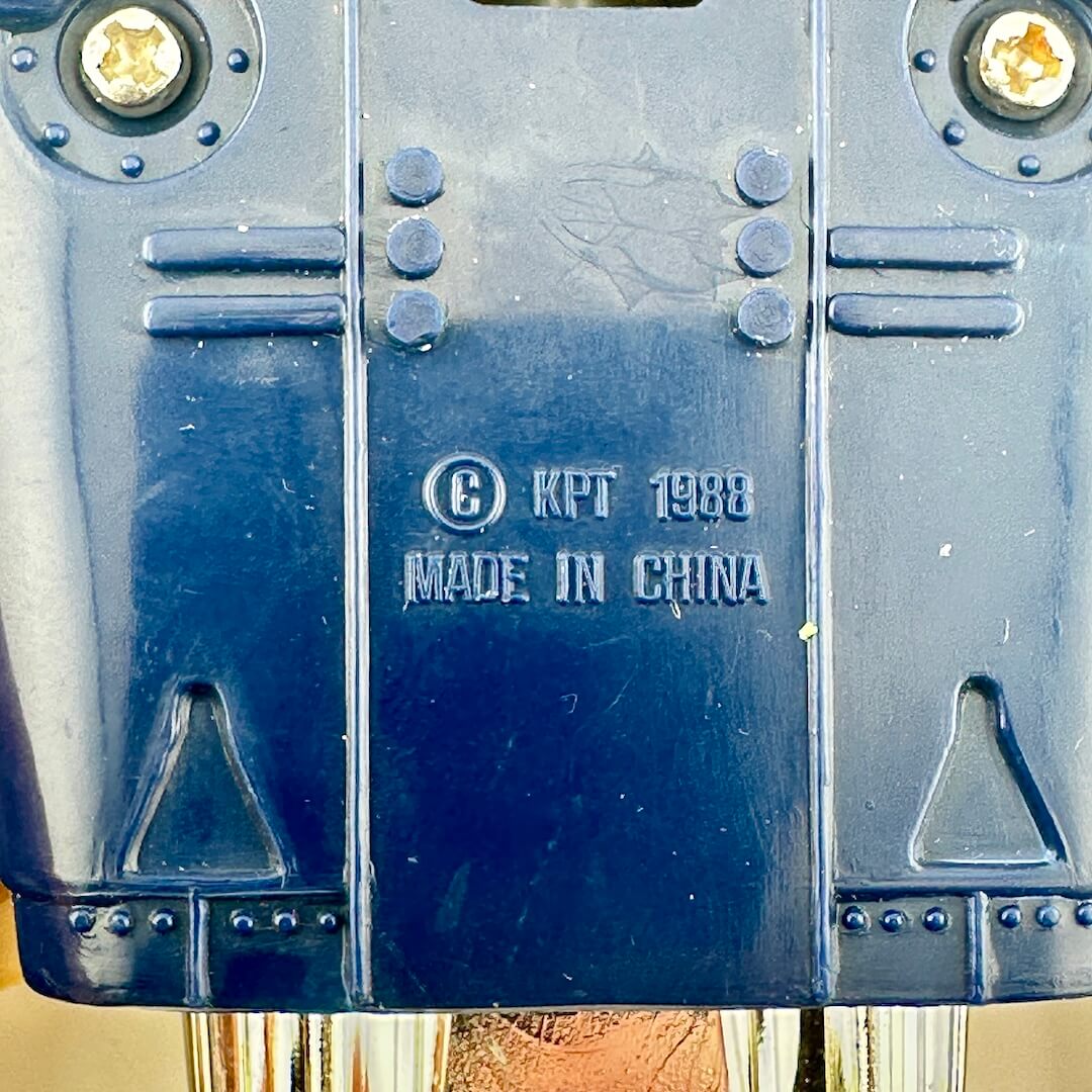 Close-up of the bottom of a dark blue object with embossed text reading '1988 MADE IN CHINA'.