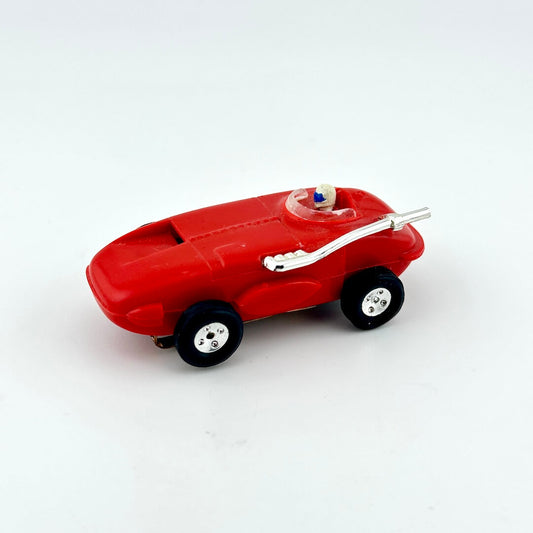 Red toy car with a white helmeted driver on a white background