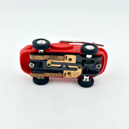 Red toy car with black wheels on a white background