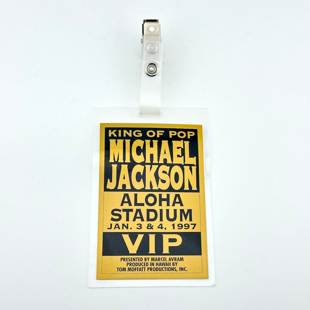 A Michael Jackson 'King of Pop' Aloha Stadium 1997 VIP event badge, featuring a gold and black design with a clear plastic sleeve and clip.