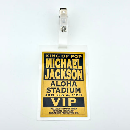 A Michael Jackson 'King of Pop' Aloha Stadium 1997 VIP event badge, featuring a gold and black design with a clear plastic sleeve and clip.
