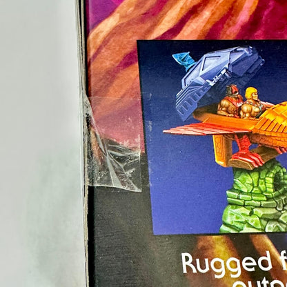 Close-up of a product packaging with a graphic of a vehicle and two figures on a rock.