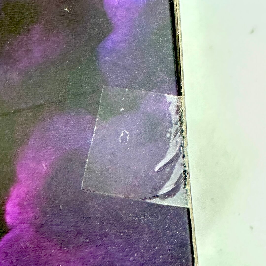 Close-up of a factory seal with purple and black colors