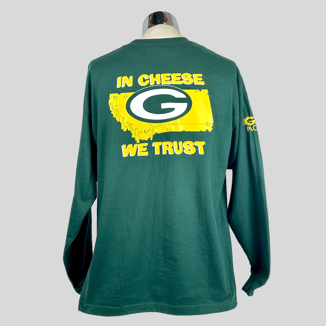 Green long-sleeve shirt with 'In Cheese We Trust' text and logo on a white background