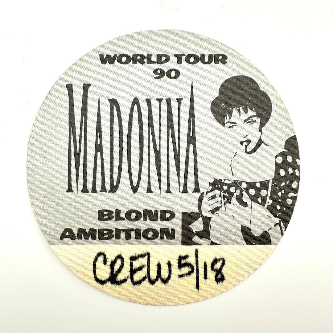 Round sticker with Madonna's name and 'Blond Ambition' tour details on a white background