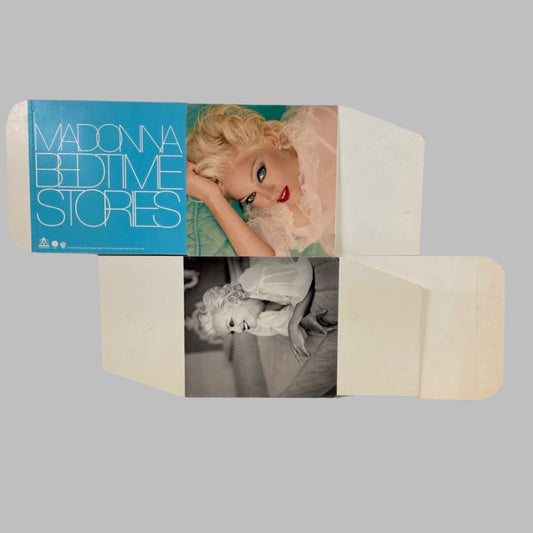 Unassembled cube display for Madonna, each visible side has image of her one in color the other black/white. 