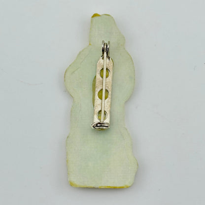 Backside of pin against white background. 