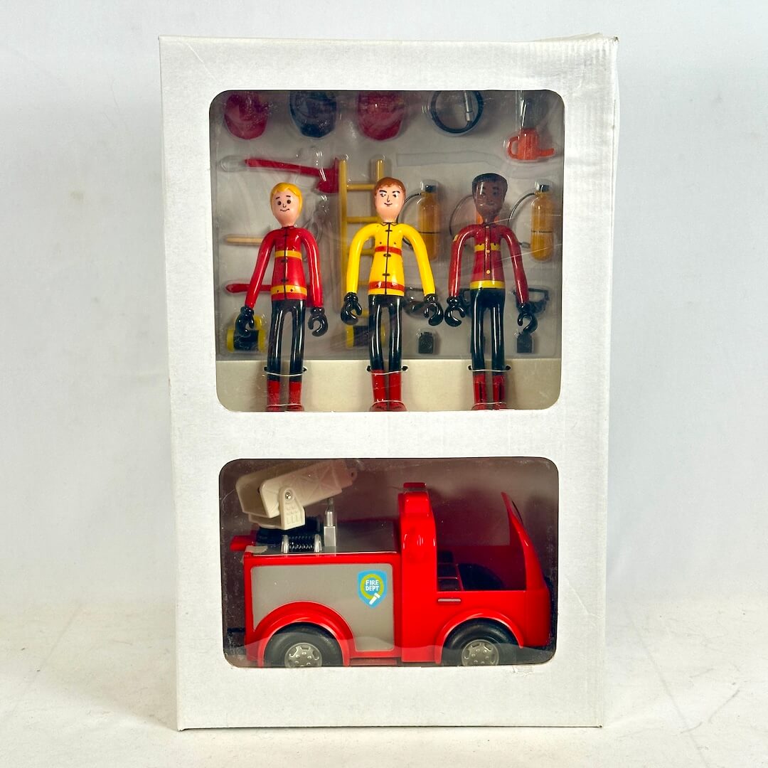 Toy fire truck and figures in a packaging box on a white background