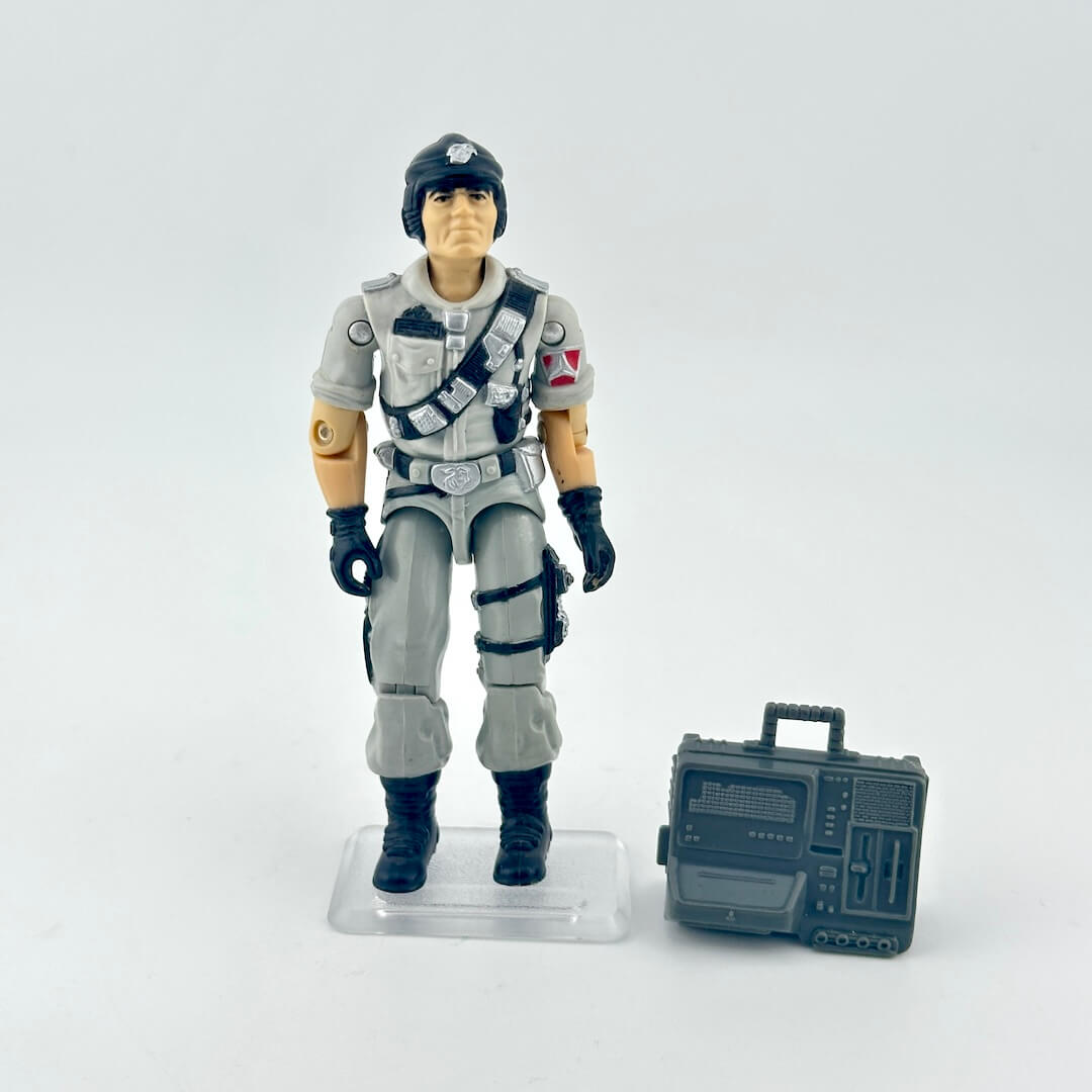 Action figure in a gray uniform with a helmet and a small radio-like device on a white background