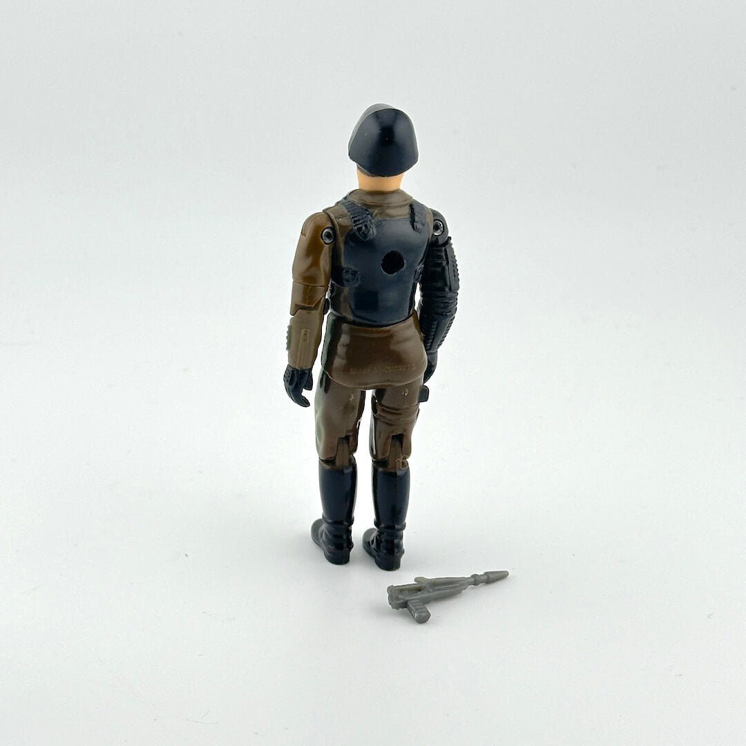 Toy figure of a soldier in military uniform with a rifle on a white background