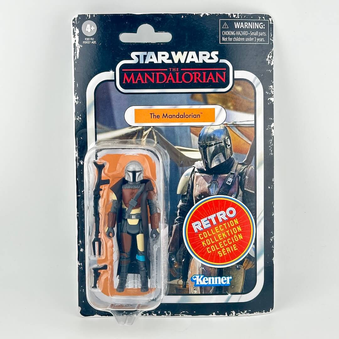 Star Wars action figure in its original blister packaging with figure in silver and brown armor with accessories. 