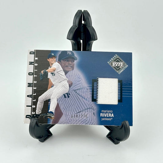Baseball trading card of Mariano Rivera held by a black card holder on a white background