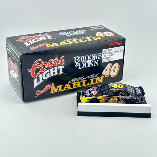 A diecast model race car displayed on a small stand in front of its branded retail box. 