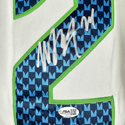 Close-up of a sports jersey showing a large number 2, an autograph across the number, & JSA authentication sticker.